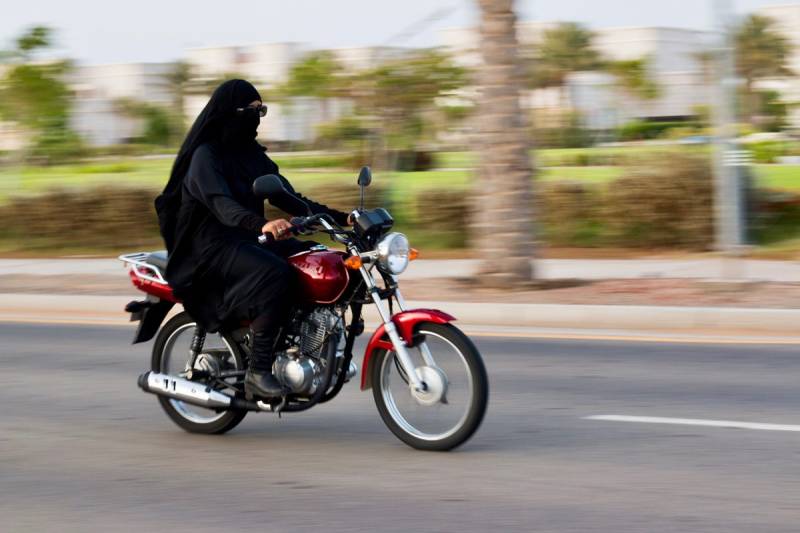 Karachi woman breaks barriers as ride-hailing motorcycle driver