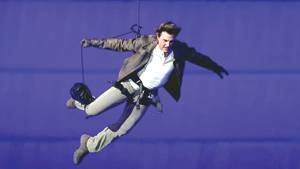 Tom Cruise descends from stadium roof in daring Olympic finale