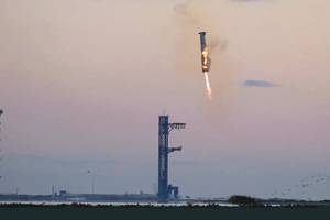 In a first, SpaceX ‘catches’ megarocket booster after test flight